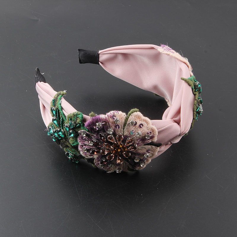 Stirnband aus Stoff mit diamantbesetzter Blume